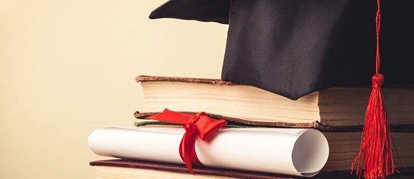 Degree with books and graduation cap